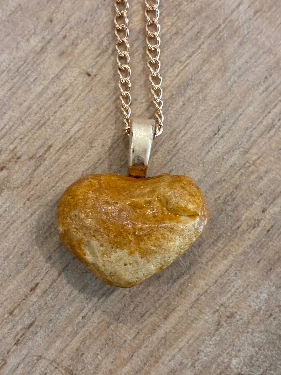 Honey Heart — naturally heart-shaped tan beach stone on a gold-tone chain